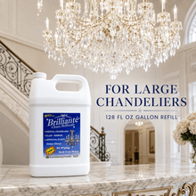 Load image into Gallery viewer, A large white plastic jug of Brillianté Crystal Clean chandelier cleaner refill stands on a marble counter in an elegant interior with a crystal chandelier, staircase, and text reading 'FOR LARGE CHANDELIERS 128 FL OZ GALLON REFILL.'.
